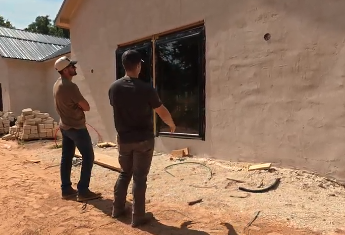 Chase and a Hiwassee Healthy Homes partner inspecting a window install